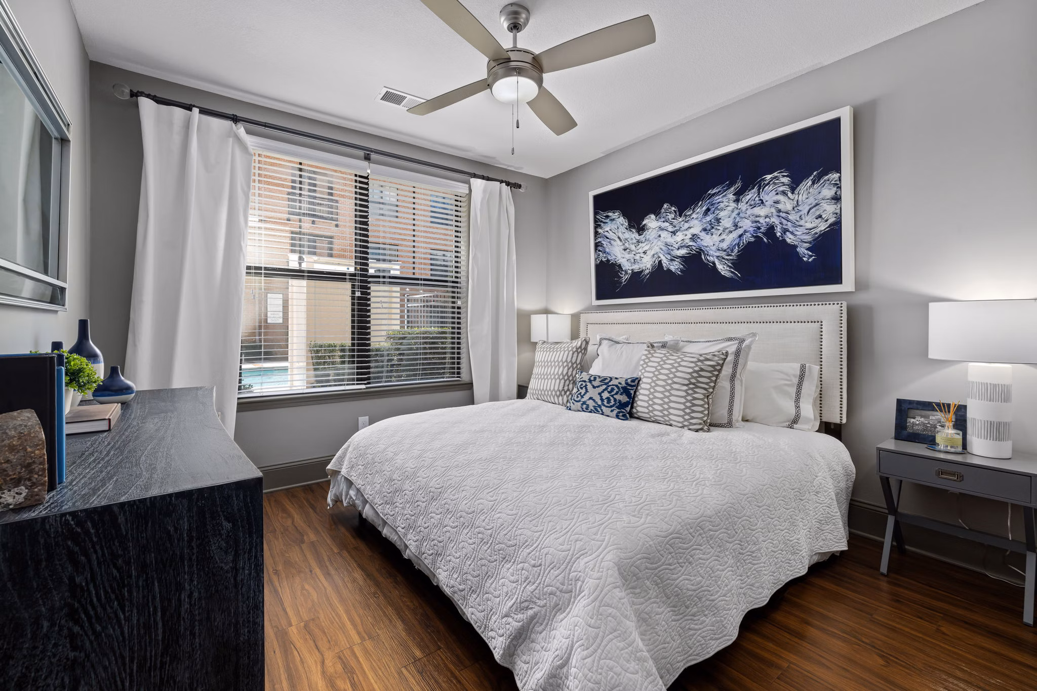 Midtown Green Apartments: Elegant bedroom featuring stylish decor and natural lighting