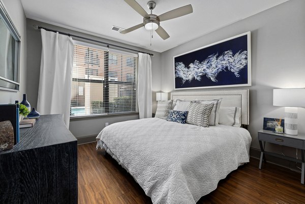 Midtown Green Apartments: Elegant bedroom featuring stylish decor and natural lighting