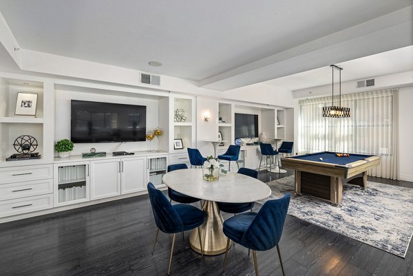 Modern clubhouse with cozy seating and pool table at Midtown Green Apartments, ideal for social gatherings and relaxation