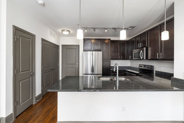 Spacious kitchen with modern appliances and sleek countertops in Midtown Green Apartments