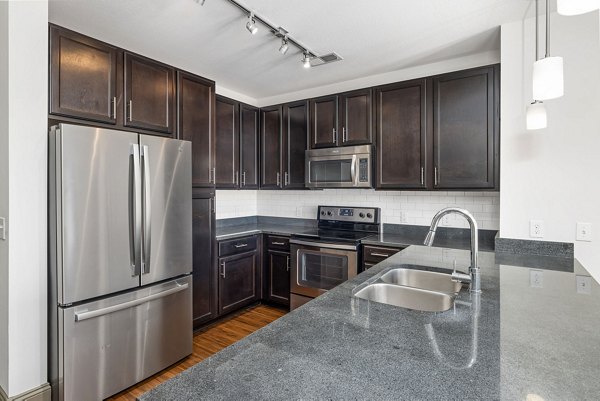 Modern kitchen with stainless steel appliances at Midtown Green Apartments