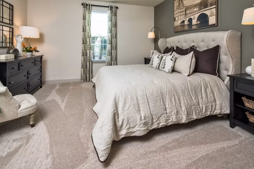 Modern bedroom with natural light and cozy furnishings at The Retreat at Trinity Apartments