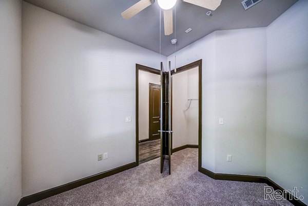 Elegant bedroom with large windows and modern decor at The Millennium Waterway apartments