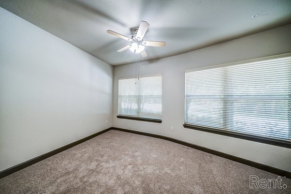 Bedroom with contemporary furnishings and soft lighting at The Millennium Waterway apartments