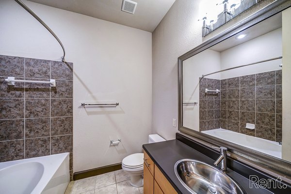 Luxurious bathroom with marble countertops and modern fixtures at The Millennium Waterway apartments
