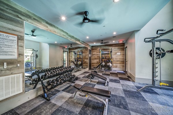 modern fitness center with state-of-the-art equipment at The Millennium Waterway luxury apartments
