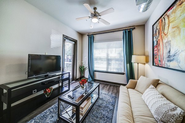 Elegant living room with modern furnishings and natural light in The Millennium Waterway apartments