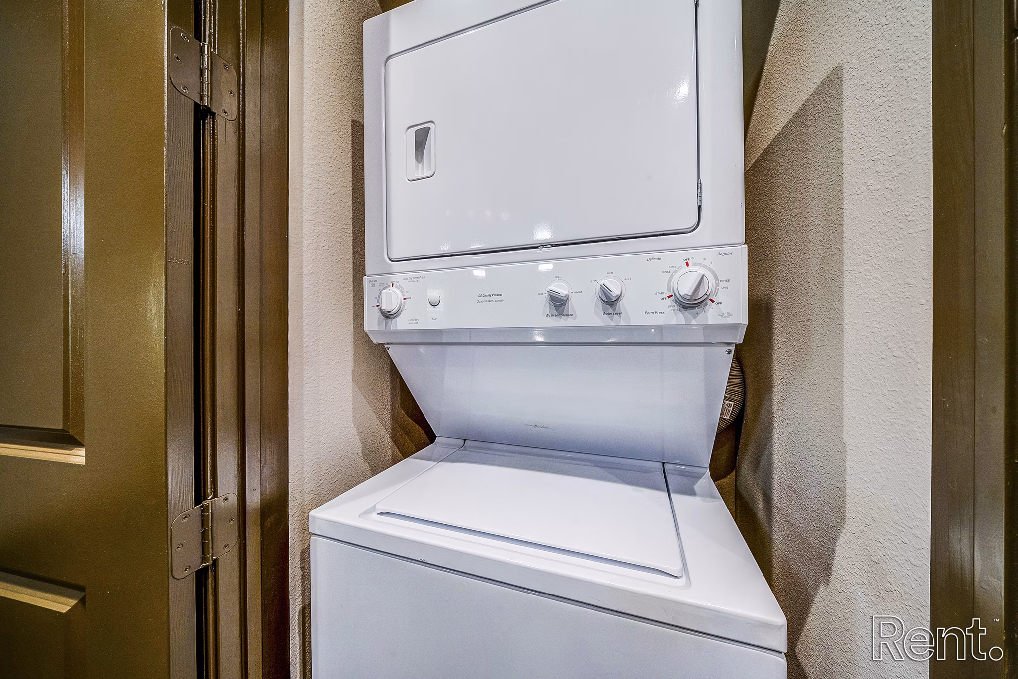 Laundry room featuring modern appliances at The Millennium Waterway apartments
