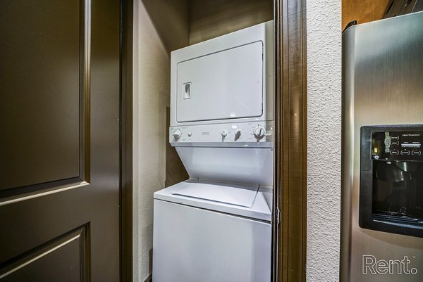 Laundry room featuring state-of-the-art appliances at The Millennium Waterway luxury apartments
