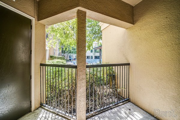 Patio with comfortable seating and greenery at The Millennium Waterway apartments