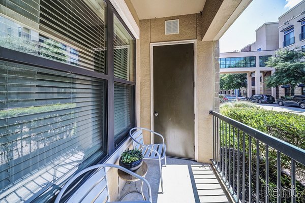 Outdoor patio with modern seating and lush greenery at The Millennium Waterway apartments in The Woodlands