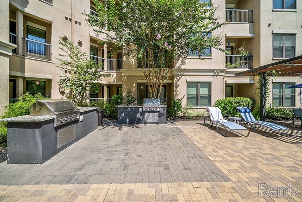 Outdoor grill area with modern seating at The Millennium Waterway luxury apartments