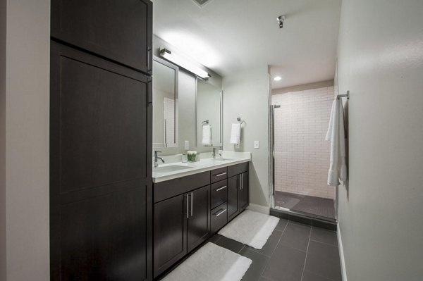 Bathroom featuring sleek fixtures and modern design at The Rice Apartments