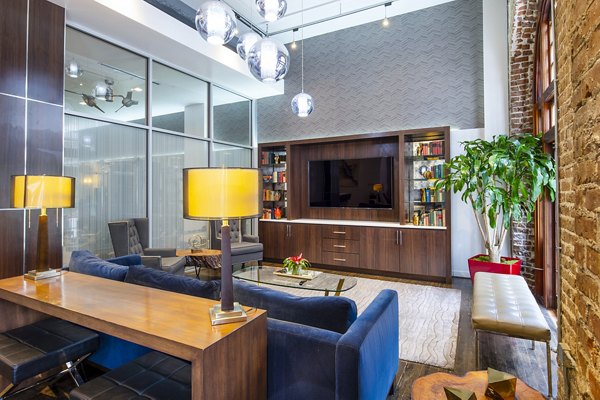Clubhouse with modern decor at The Rice Apartments featuring communal seating and entertainment areas