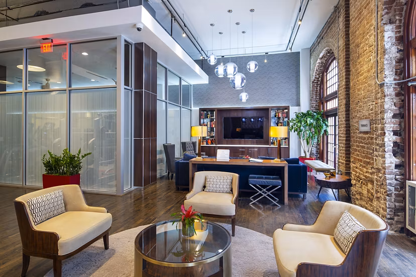 Clubhouse featuring modern decor and ample seating at The Rice Apartments, a luxury apartment community