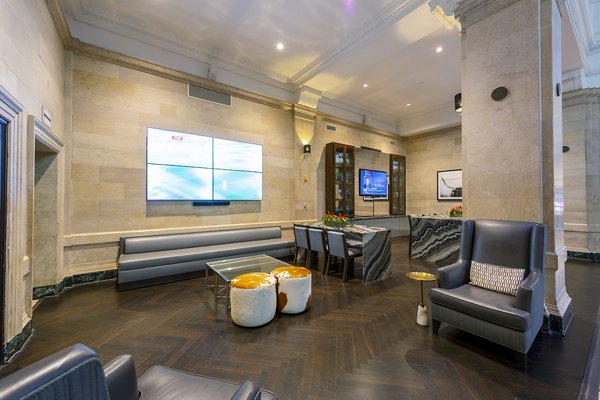 Modern gym with free weights and cardio machines at The Rice Apartments clubhouse