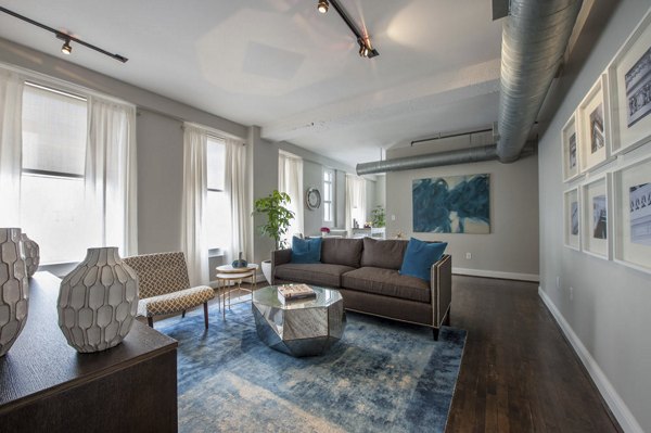 Spacious living room with modern furnishings and large windows in The Rice Apartments