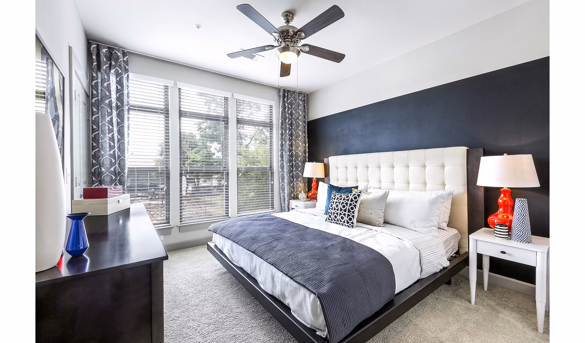 Modern bedroom with cozy furnishings at 5th Street Commons Apartments