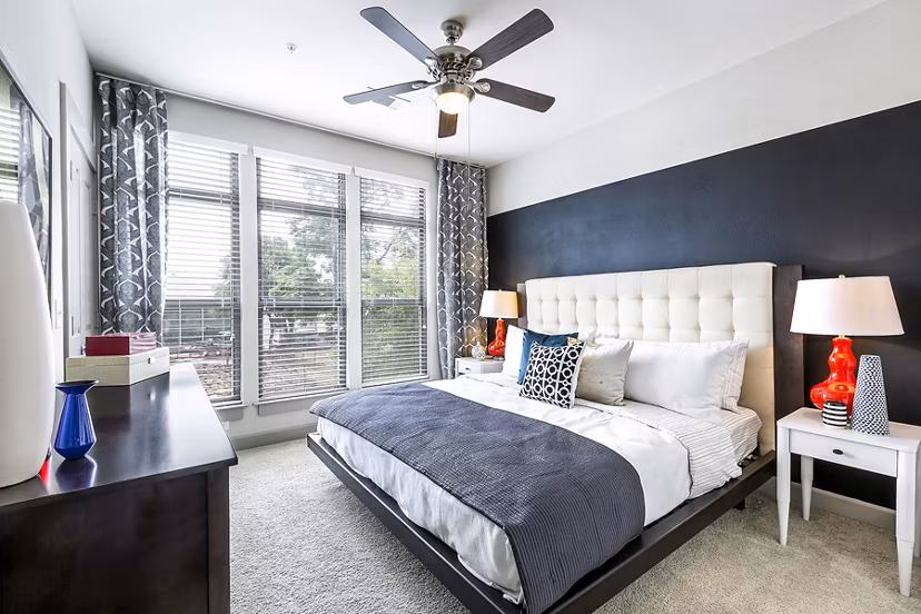 Modern bedroom with cozy furnishings at 5th Street Commons Apartments