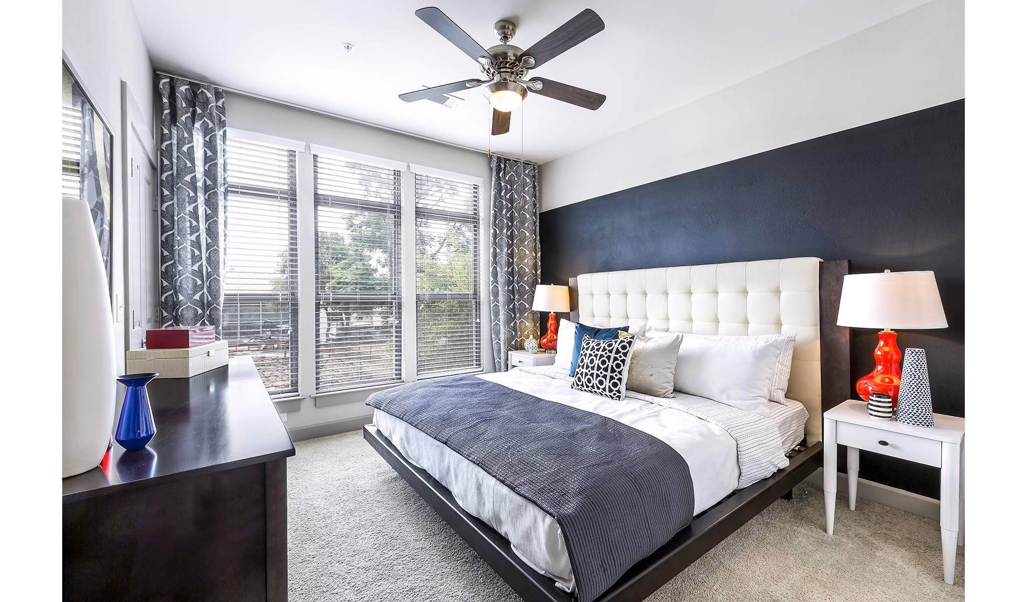 Modern bedroom with cozy furnishings at 5th Street Commons Apartments