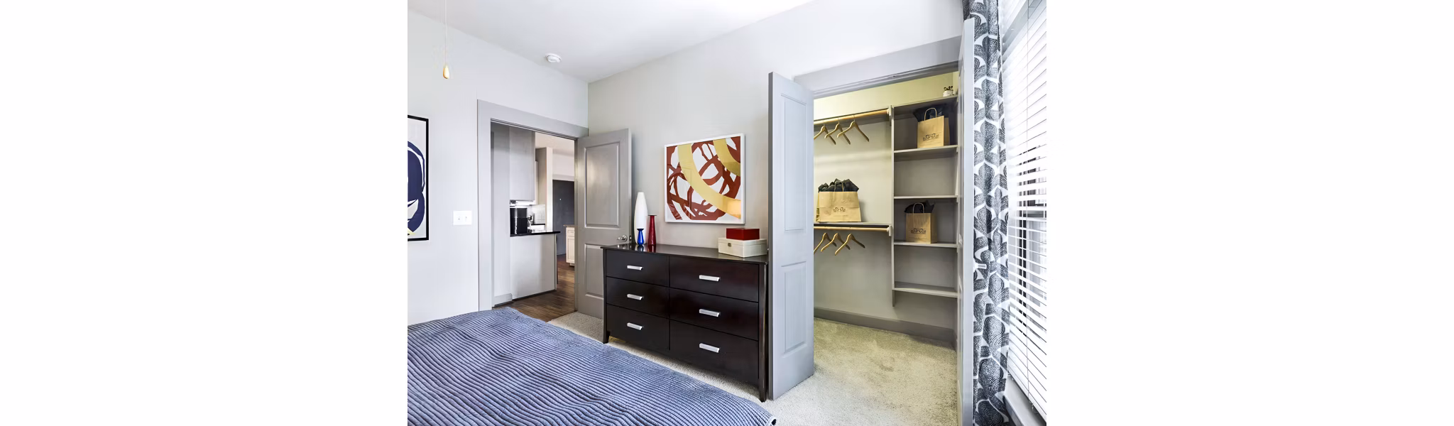 Elegant bedroom with modern furnishings at 5th Street Commons Apartments, offering luxury living amenities