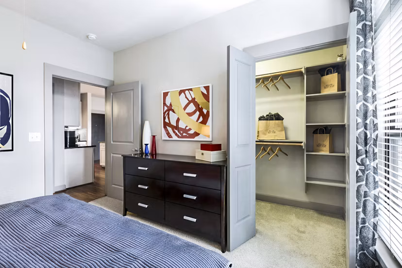 Elegant bedroom with modern furnishings at 5th Street Commons Apartments, offering luxury living amenities
