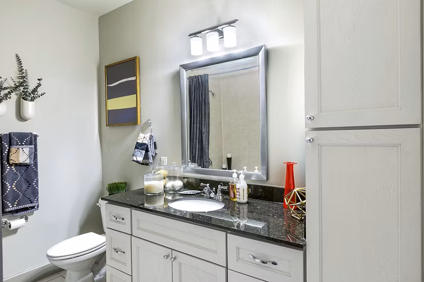 Bathroom featuring sleek fixtures and modern design at 5th Street Commons Apartments