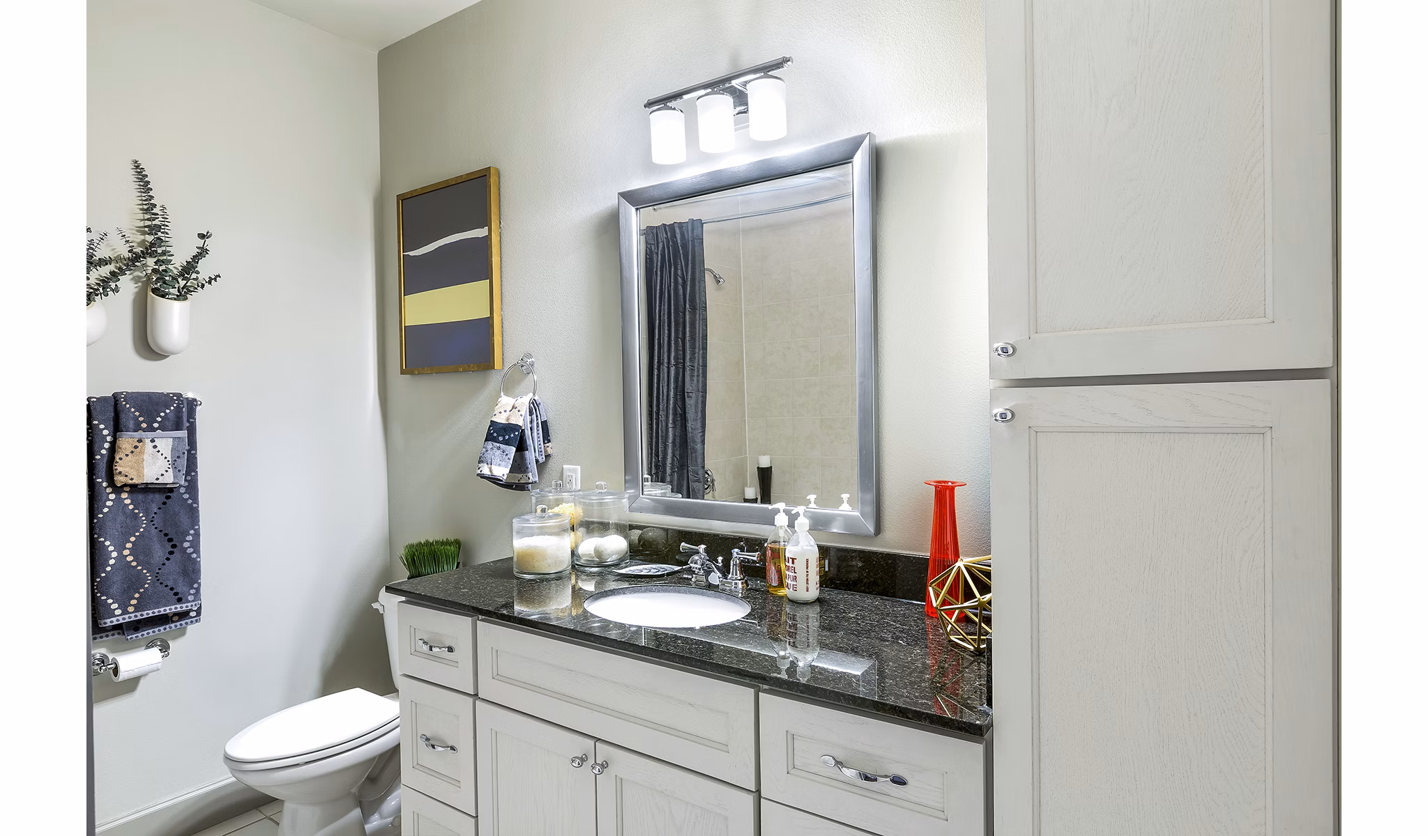 Bathroom featuring sleek fixtures and modern design at 5th Street Commons Apartments