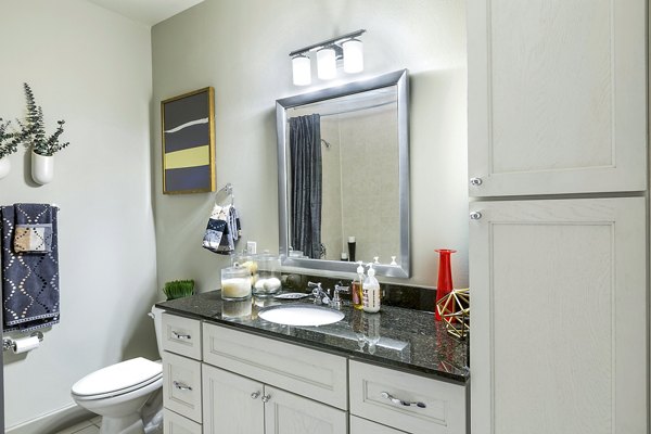 Bathroom featuring sleek fixtures and modern design at 5th Street Commons Apartments