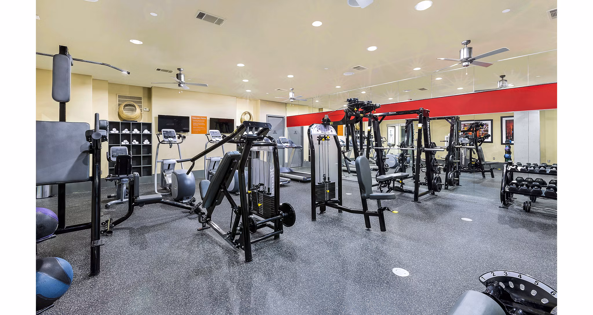 Fitness center with modern equipment at 5th Street Commons Apartments