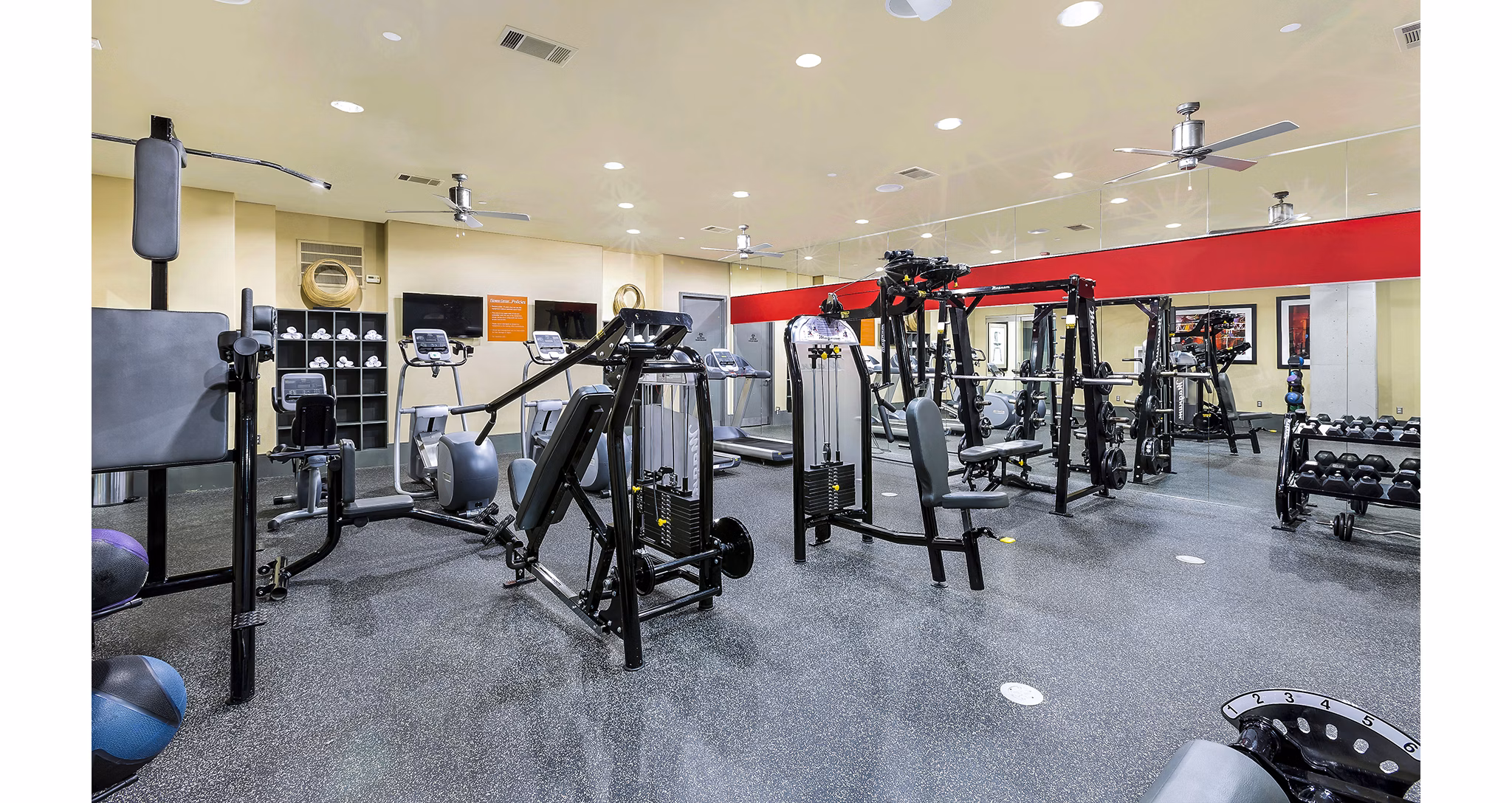 Fitness center with modern equipment at 5th Street Commons Apartments