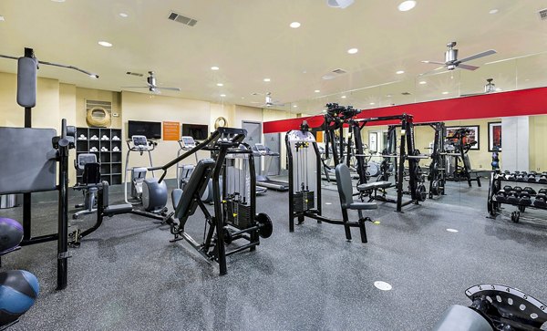 Fitness center with modern equipment at 5th Street Commons Apartments