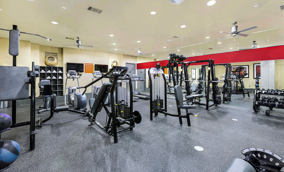 Fitness center with modern equipment at 5th Street Commons Apartments