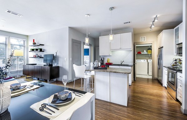 Modern kitchen with stainless steel appliances at 5th Street Commons Apartments