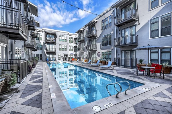 Resort-style pool at 5th Street Commons Apartments with lounging areas