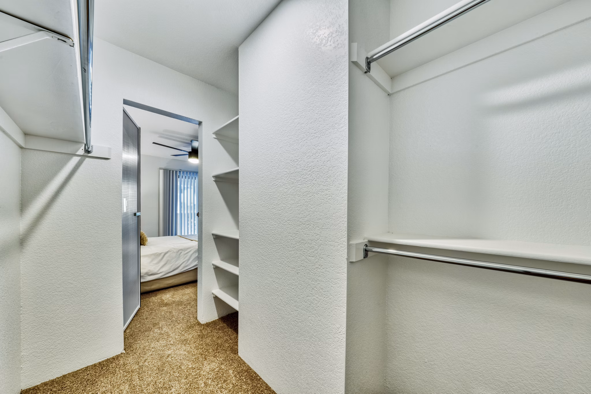 Modern bedroom with stylish decor and large windows at Be Mesa Apartments