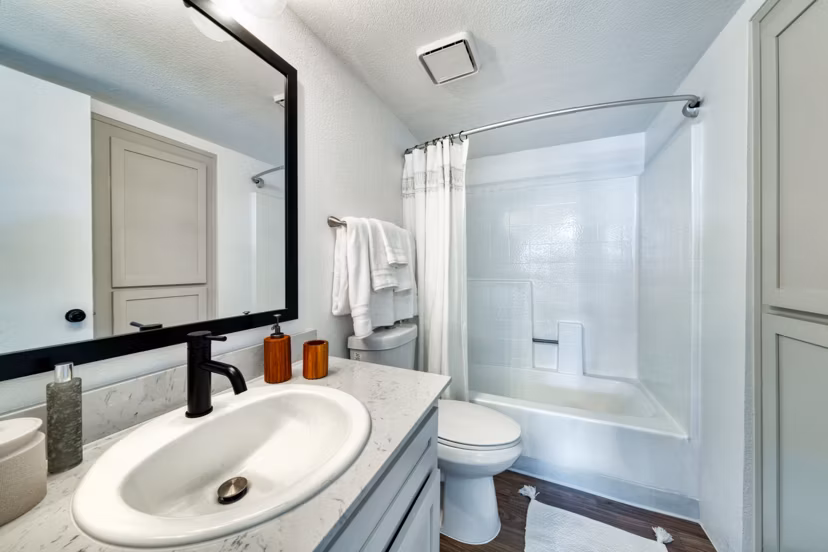 Modern bathroom featuring sleek fixtures and ample lighting at Be Mesa Apartments