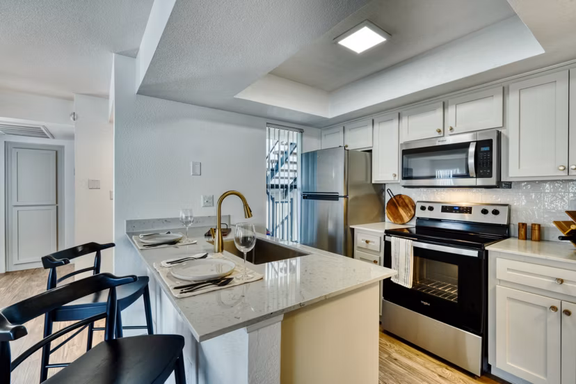 Modern kitchen featuring sleek cabinetry and stainless steel appliances at Be Mesa Apartments, luxury living by Greystar