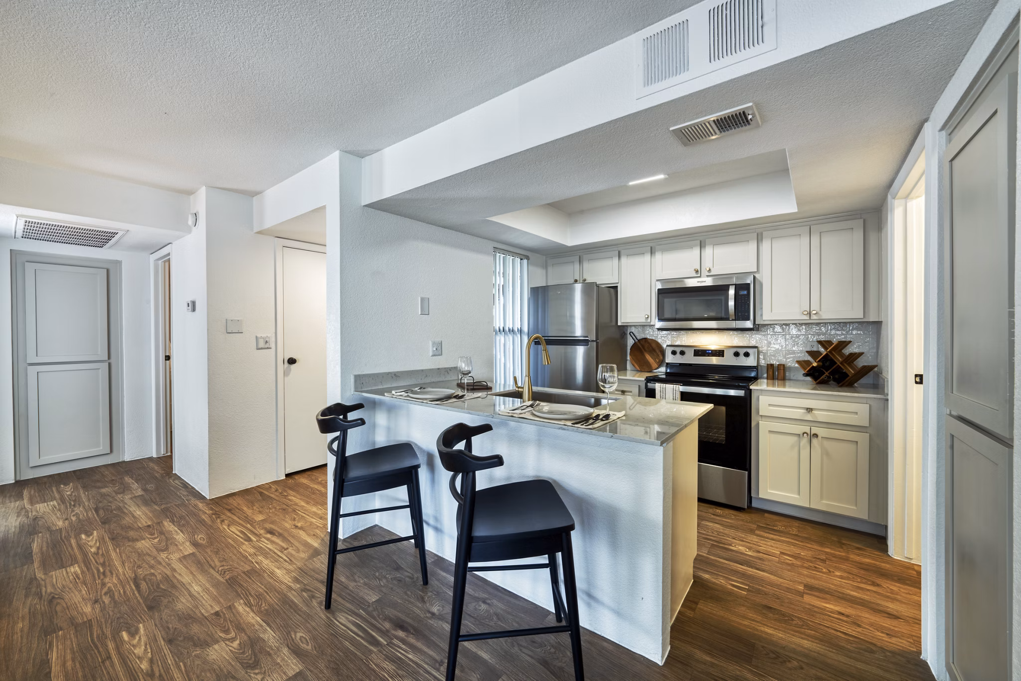 Modern kitchen featuring sleek cabinetry and stainless steel appliances at Be Mesa Apartments, luxury living by Greystar