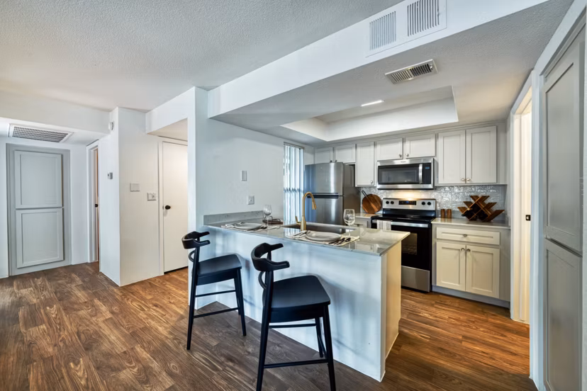 Modern kitchen with stainless steel appliances at Be Mesa Apartments, offering luxury living experiences