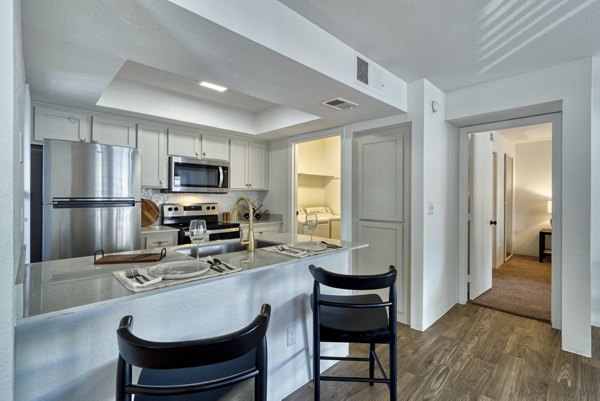 Modern kitchen with stainless steel appliances at Be Mesa Apartments, offering luxury living experiences