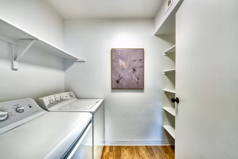 Laundry room with top-load washers and dryers in Be Mesa Apartments
