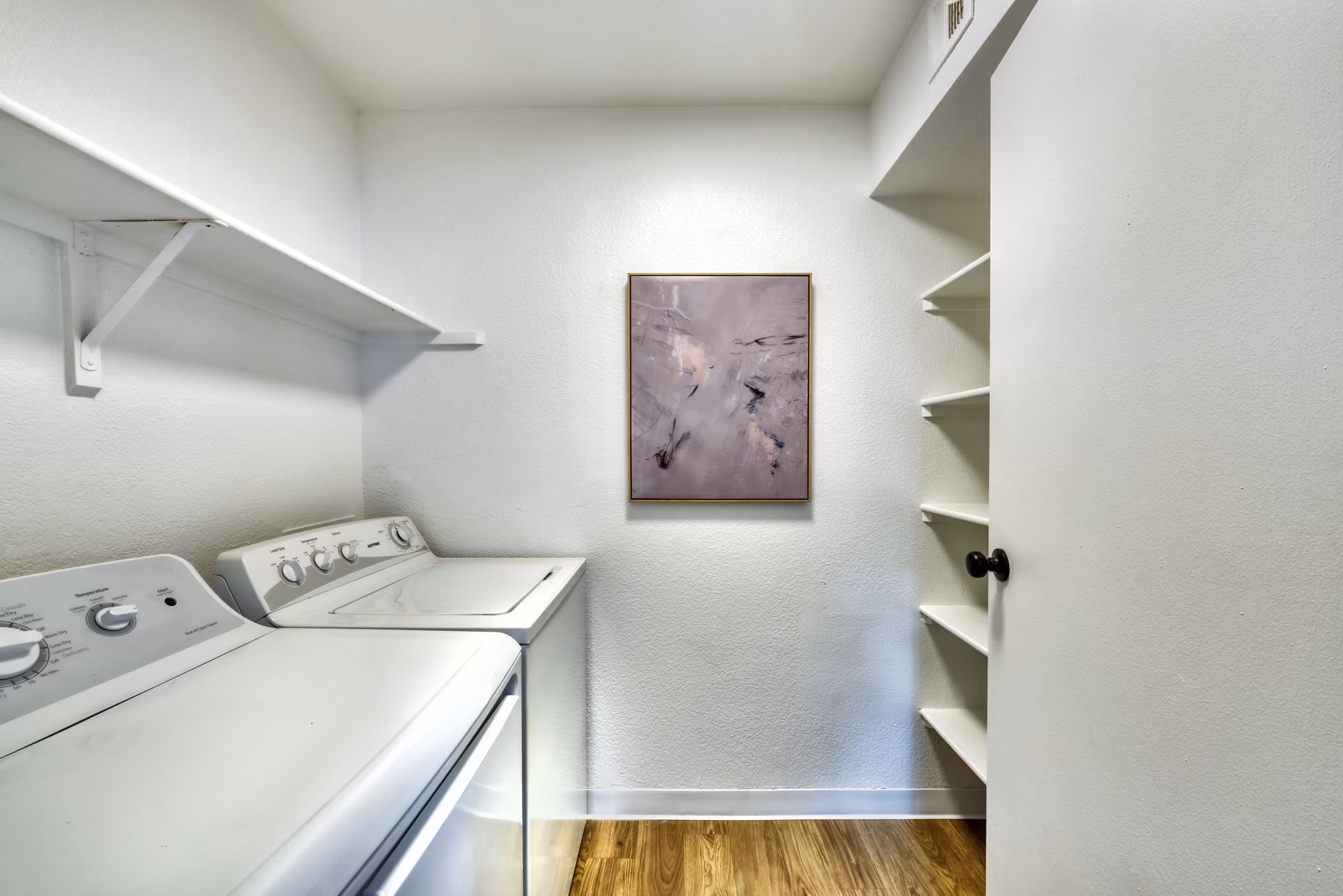 Laundry room with top-load washers and dryers in Be Mesa Apartments