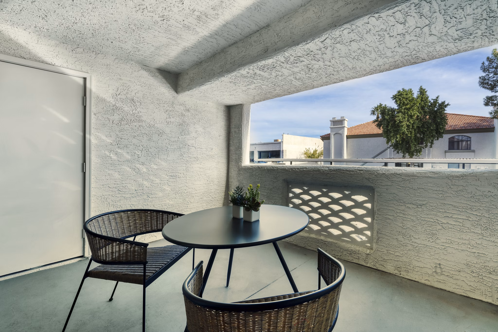 Patio featuring outdoor seating and lush landscaping at Be Mesa Apartments, a luxury property in a prime location
