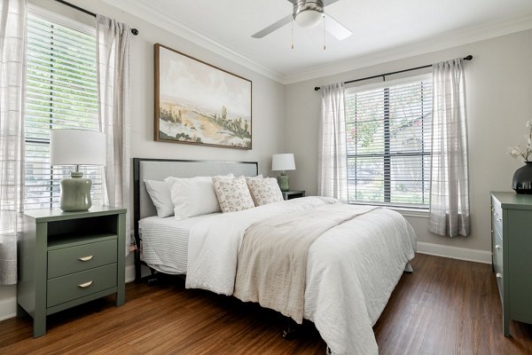 Elegant bedroom with natural light and modern decor at Lantana Hills Apartments
