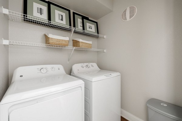 Modern laundry room with energy-efficient washers at Lantana Hills Apartments