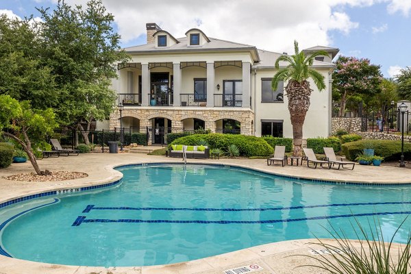Resort-style pool with lounge chairs at Lantana Hills Apartments, offering a relaxing retreat for residents