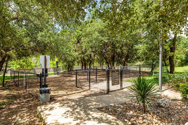 Modern recreational area with outdoor seating and lush greenery at Lantana Hills Apartments