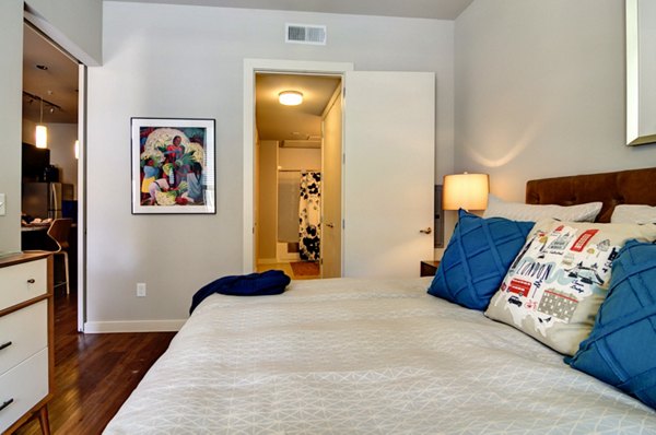Bedroom featuring modern decor and abundant natural light at River House Apartments
