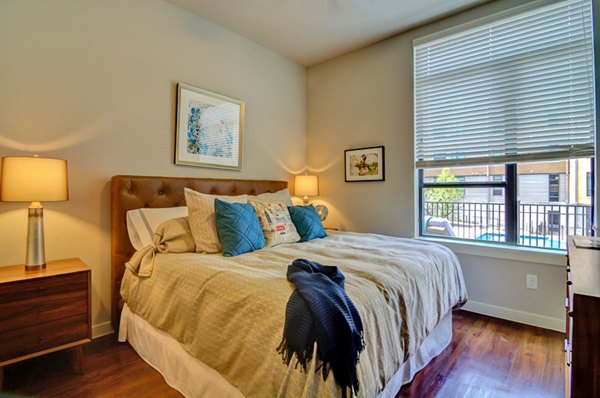 Modern bedroom with stylish decor at River House Apartments in Greystar luxury community